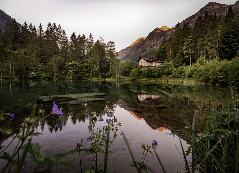 The Christlessee in the Trettach valley at dawn, clear water reflecting the peaks